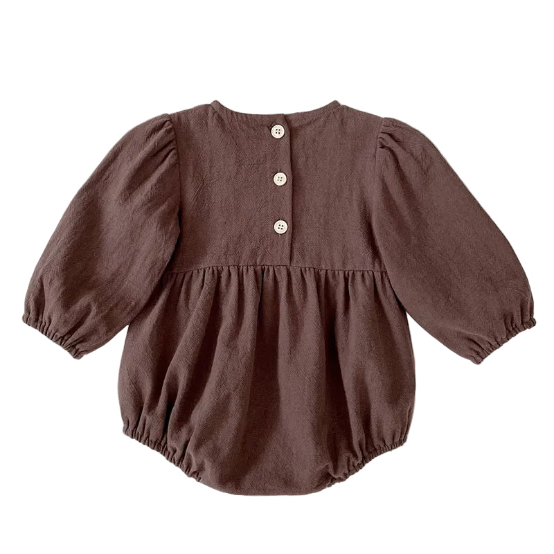 Back view of the brown long sleeve baby girl bubble romper showing the gathered elastic leg openings and back button closures.