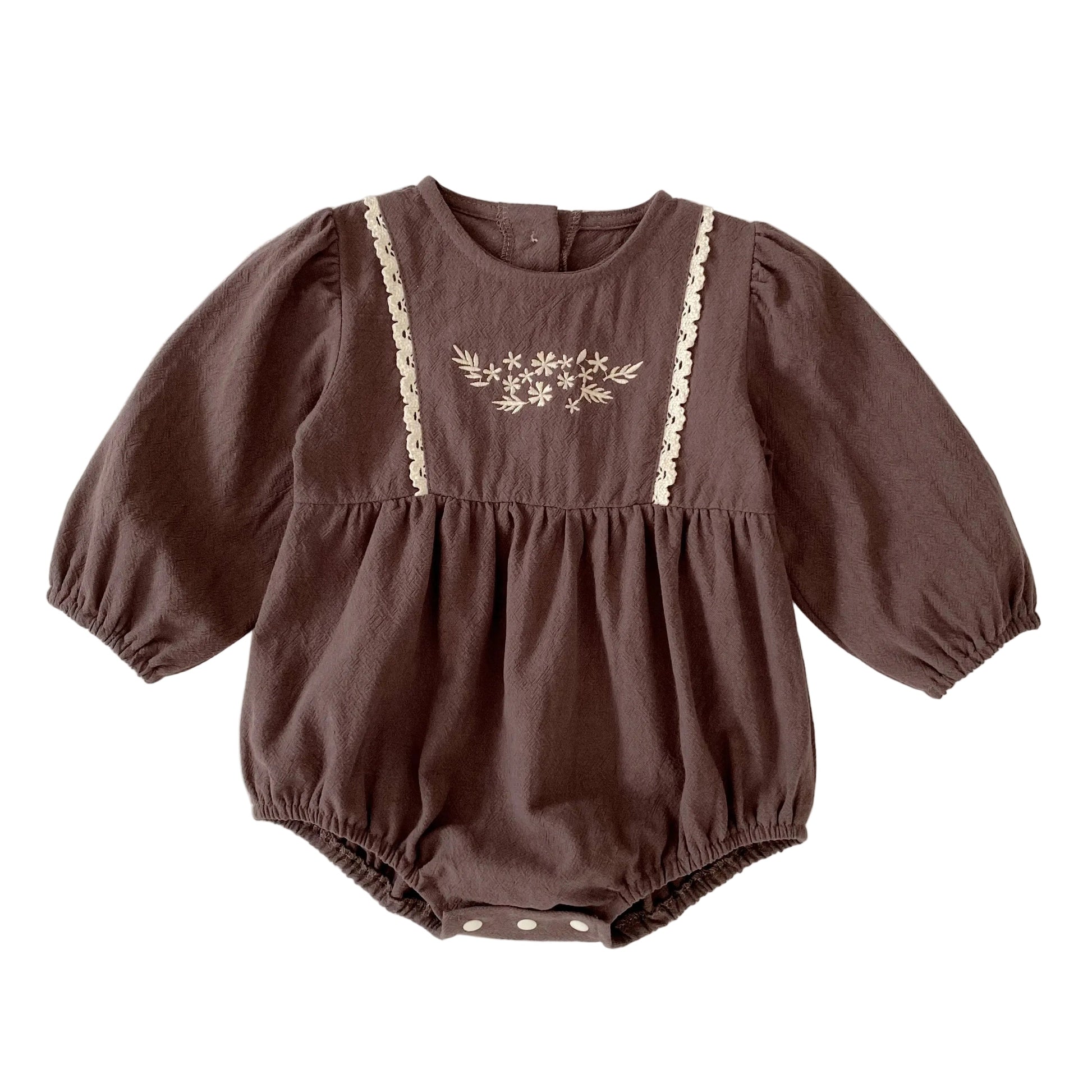Front view of a vintage-inspired brown long sleeve baby girl bubble romper featuring floral embroidery and lace trim on the chest.