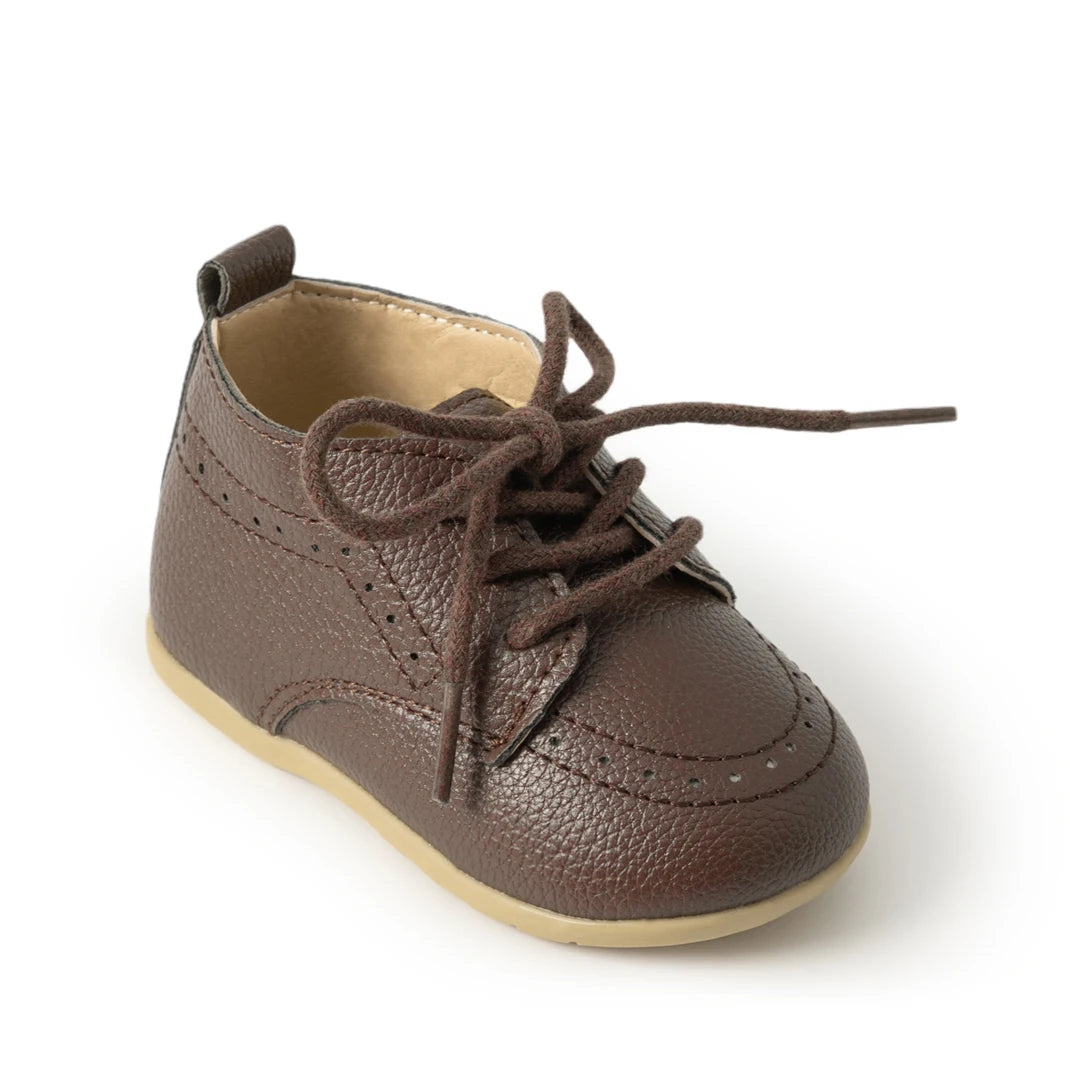 Close-up studio shot of a single Kidsely brown pebbled faux leather lace-up formal oxford shoe for infants.