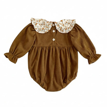 Back view of the warm brown ribbed corduroy baby romper showing the back neck button closures.