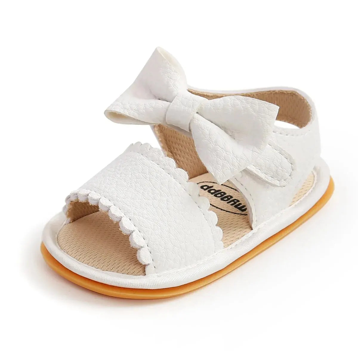 Pair of tan brown leather baby girl first walker sandals featuring a large textured bowknot and classic scalloped edges.