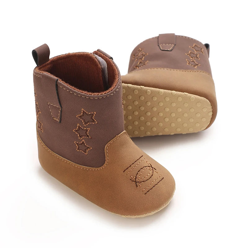 Side view of brown and tan baby western boots showing the soft fabric sole with silicone anti-slip grip dots.