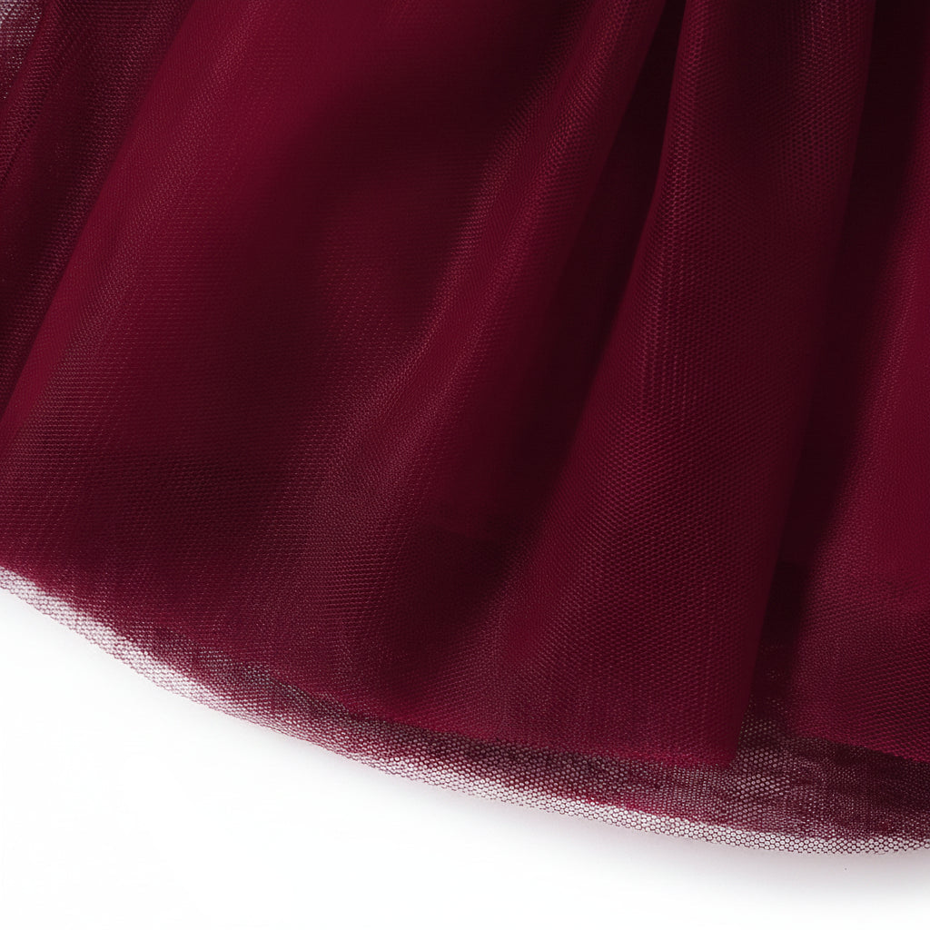 Close up detail of the layered burgundy tulle skirt hem on the girls special occasion dress.