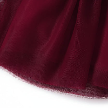 Close up detail of the layered burgundy tulle skirt hem on the girls special occasion dress.