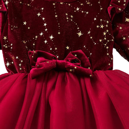 Close up of the girls burgundy stretch velvet dress bodice highlighting the shimmering gold star pattern and matching velvet bow.