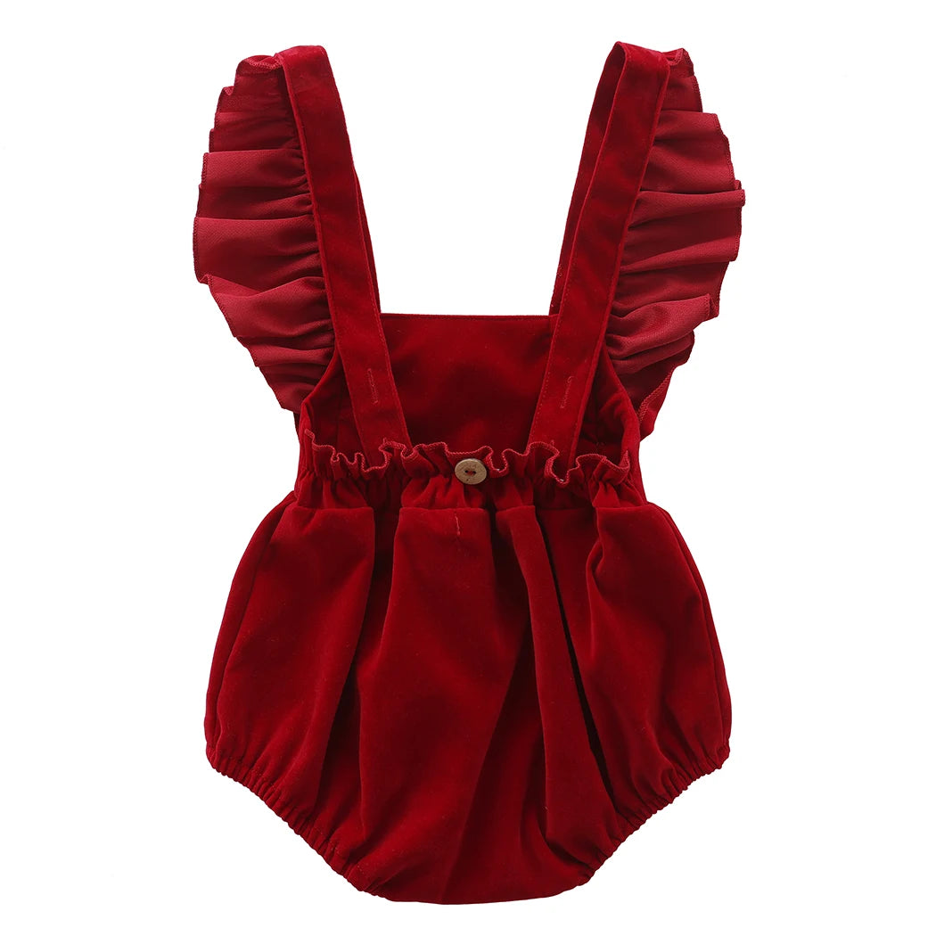 Full back view of the red velvet-feel holiday romper showcasing the ruffled straps and elastic gathered waist.