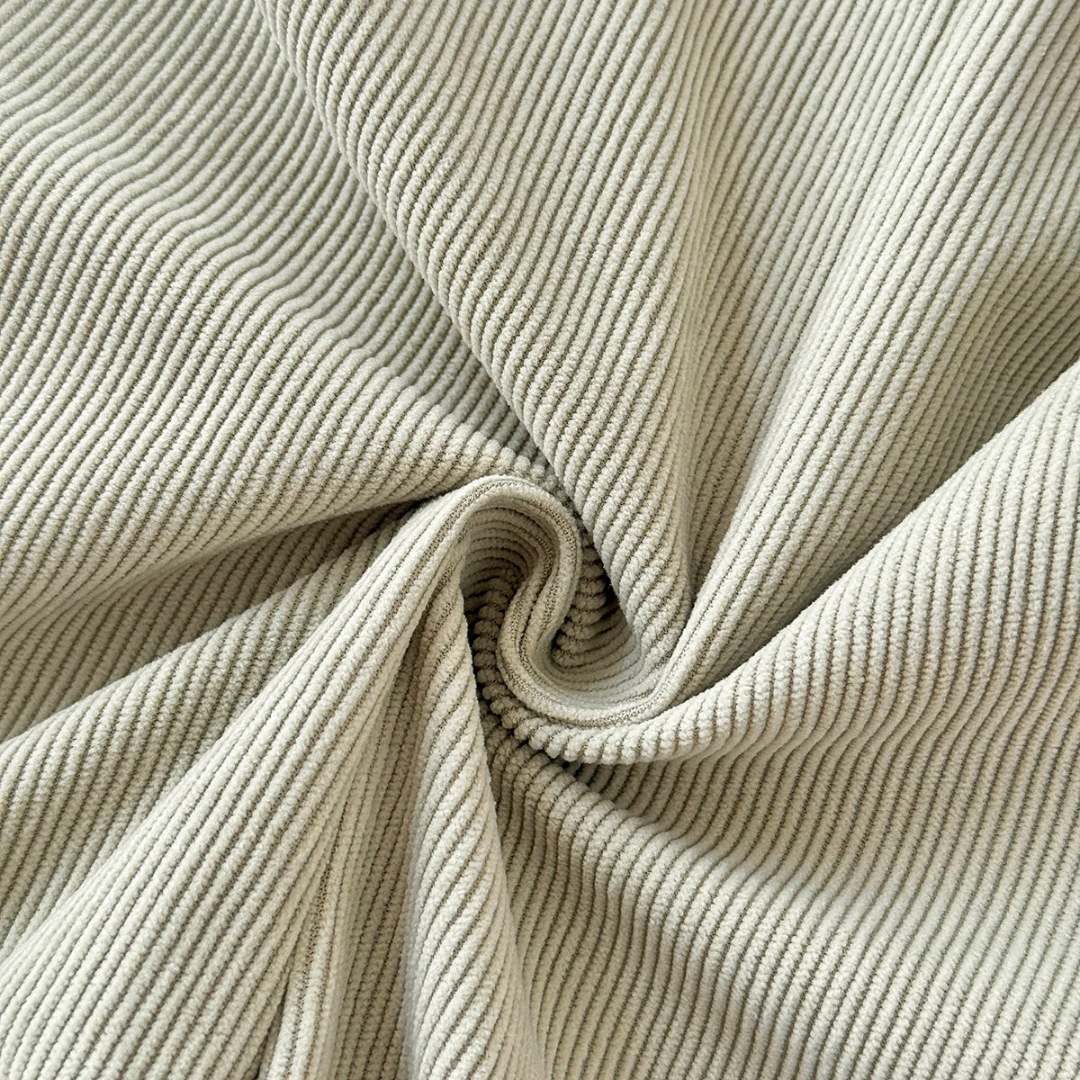Close-up showing the soft, ribbed knit texture of the Sage Green corduroy fabric.