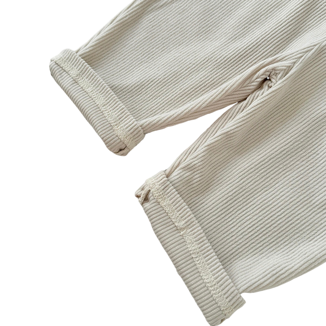 Close-up detail of the rolled pant cuffs and textured ribbed corduroy fabric on Kidsely toddler overalls.
