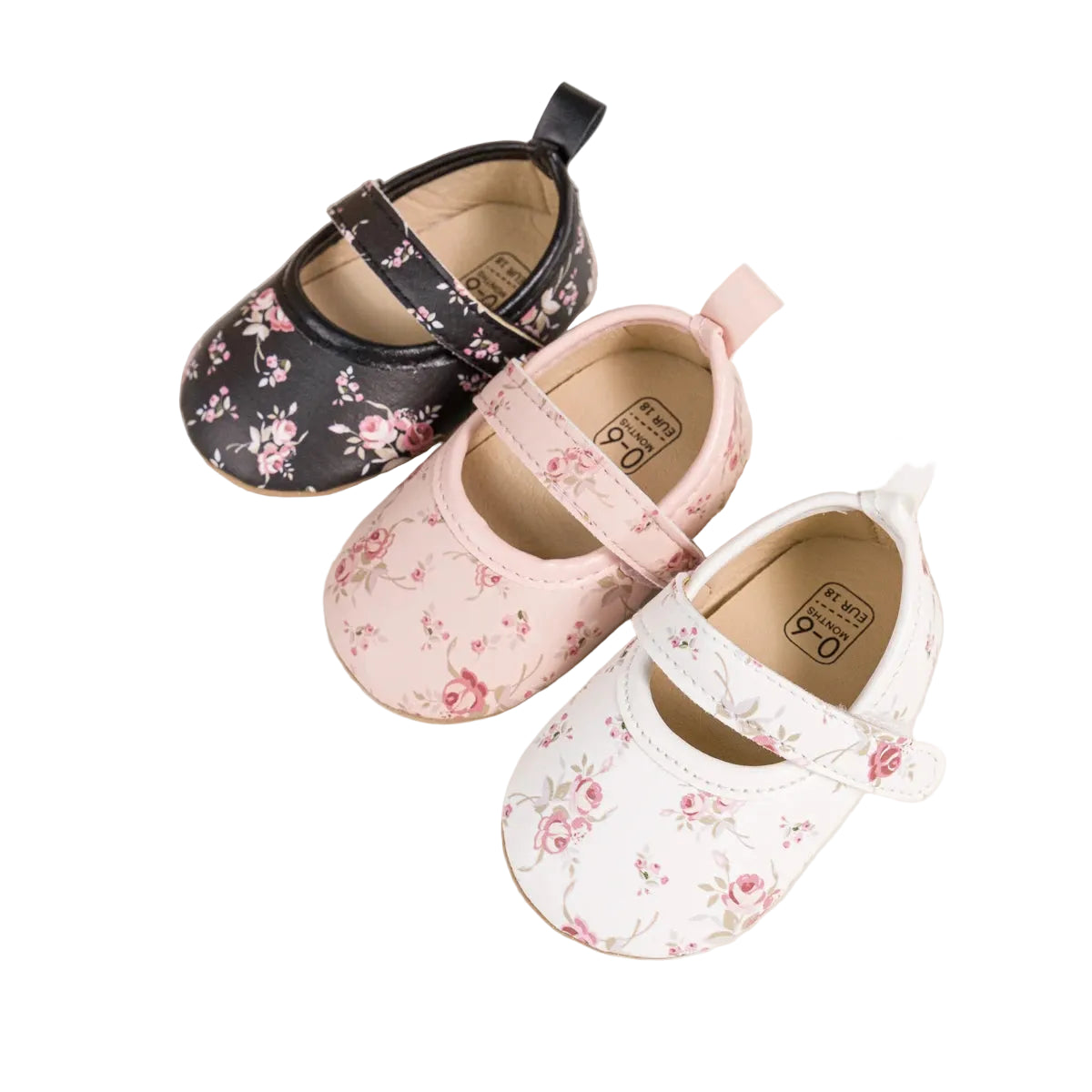 Three pairs of cottagecore baby girl floral Mary Jane shoes in black, pink, and white.
