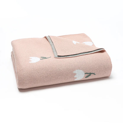 Close-up macro view of the premium ribbed edge stitching and heavy-duty knit texture of the pink cotton baby blanket.