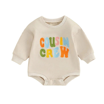 Neutral cream baby sweatshirt bodysuit featuring colorful Cousin Crew chenille embroidery