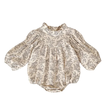 Full front view of a cream and gray floral baby bubble romper with long puff sleeves and a ruffle collar, laid flat.