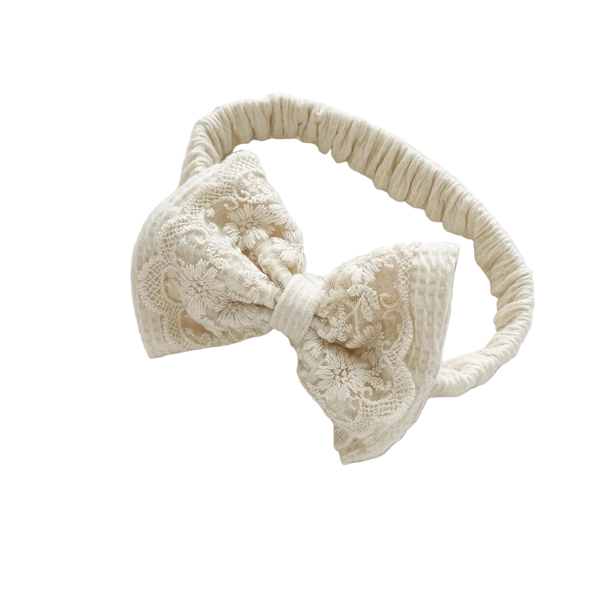 Stretchy cream off-white waffle knit baby girl hair accessory headband with a lace bow overlay.