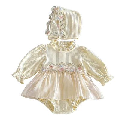 Full front view of a baby girl's cream long-sleeve ribbed romper dress with a tulle skirt and matching floral embroidered bonnet.