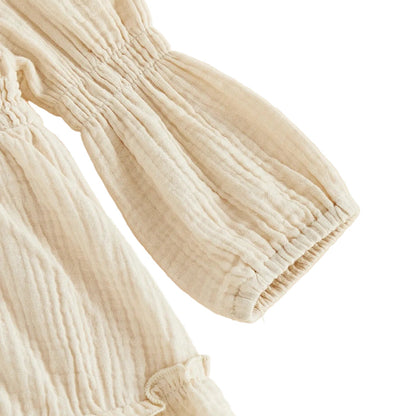 Close-up detail of the long balloon sleeve and gathered ruffled cuff on the cream goose baby romper.