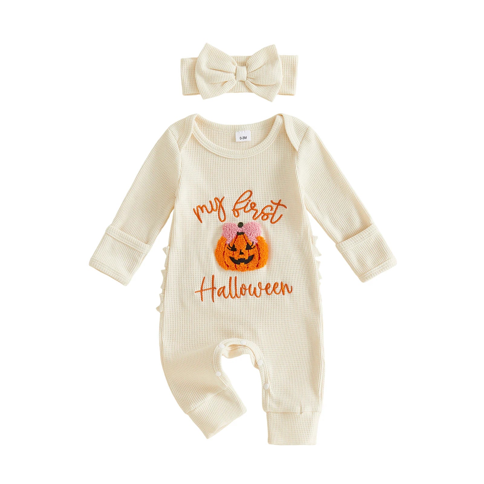 Cream-colored ribbed long-sleeve baby romper featuring a "My first Halloween" pumpkin design, paired with a matching bow headband.