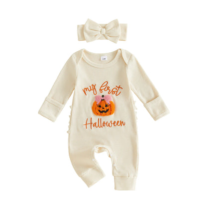Cream-colored ribbed long-sleeve baby romper featuring a "My first Halloween" pumpkin design, paired with a matching bow headband.