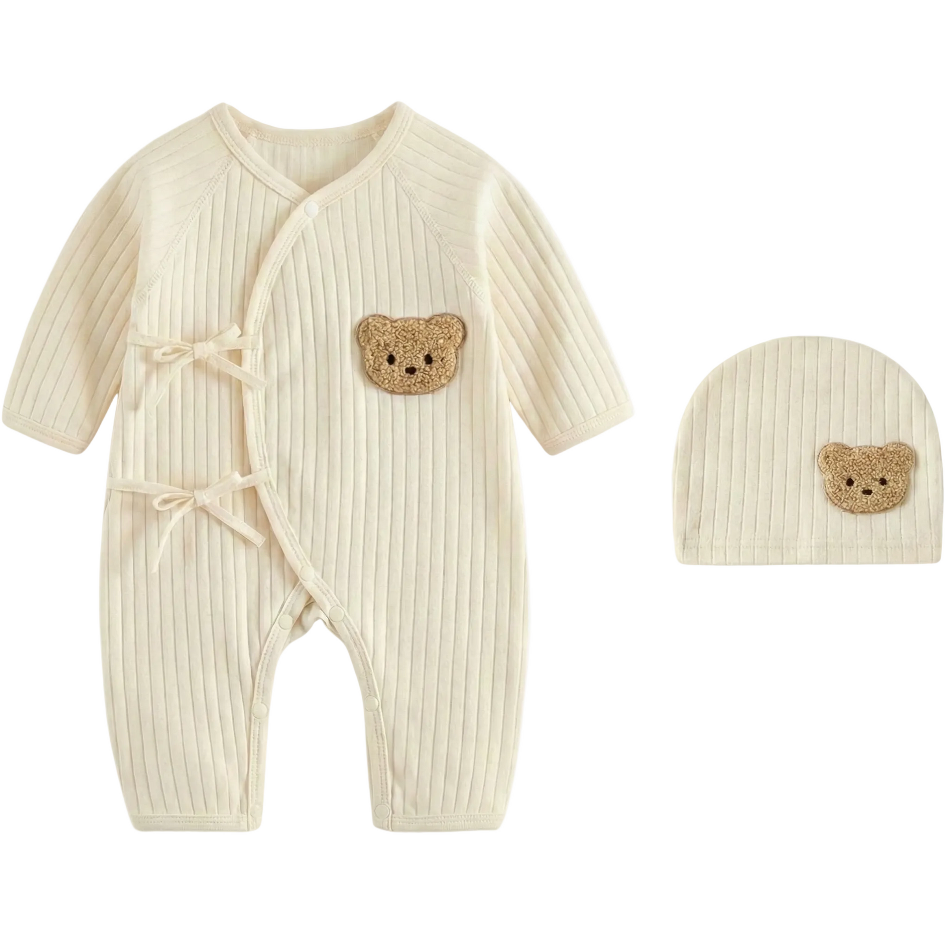 Cream colored ribbed cotton newborn jumpsuit with wrap-style front and textured beige teddy bear detail on chest and hat.