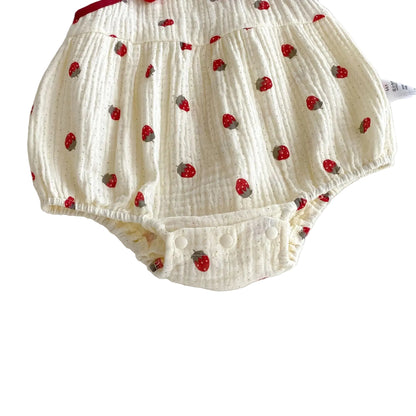 Close-up of the bottom back of the cream strawberry romper highlighting the flexible, elasticized leg openings.