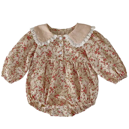 Full front view of the cream vintage floral baby girl bubble romper featuring long sleeves, a relaxed fit, and a lace-trimmed Peter Pan collar.
