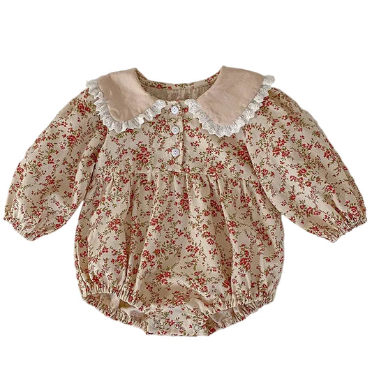 Full front view of the cream vintage floral baby girl bubble romper featuring long sleeves, a relaxed fit, and a lace-trimmed Peter Pan collar.