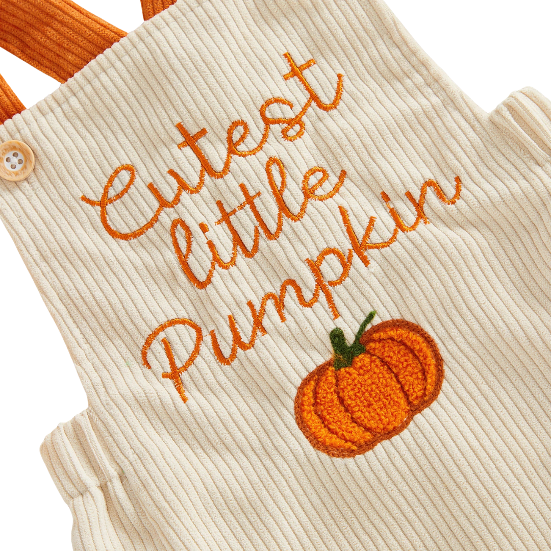 Close-up detail of the orange "Cutest little Pumpkin" text and pumpkin embroidery on the beige baby corduroy romper.