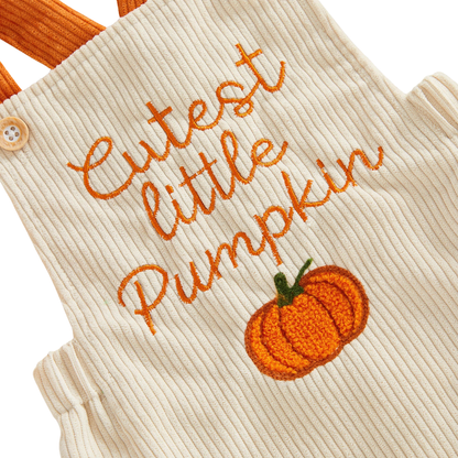 Close-up detail of the orange "Cutest little Pumpkin" text and pumpkin embroidery on the beige baby corduroy romper.