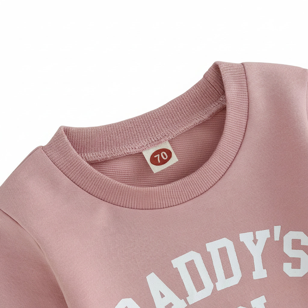 Close-up of the ribbed crew neck collar and letter print on the pink Daddy's Girl baby sweatshirt.