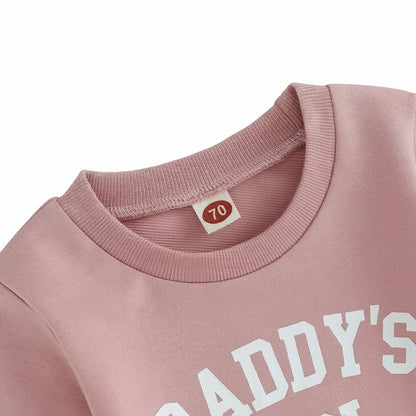 Close-up of the ribbed crew neck collar and letter print on the pink Daddy's Girl baby sweatshirt.