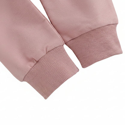 Close-up detail of the ribbed wrist cuffs on the long sleeve pink baby sweatshirt.