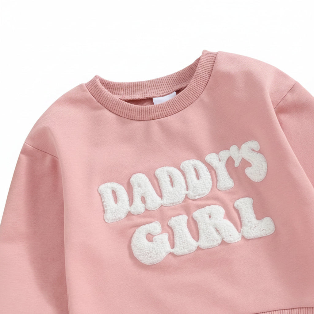 Close-up of the fuzzy white "Daddy's Girl" letter embroidery and crew neckline on the pink baby bubble romper.