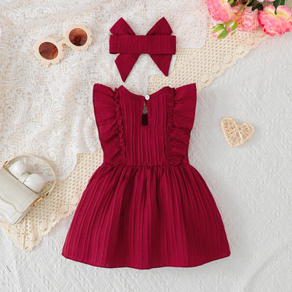 Flat lay showing the back view of the dark red infant sundress, highlighting the back keyhole button closure.