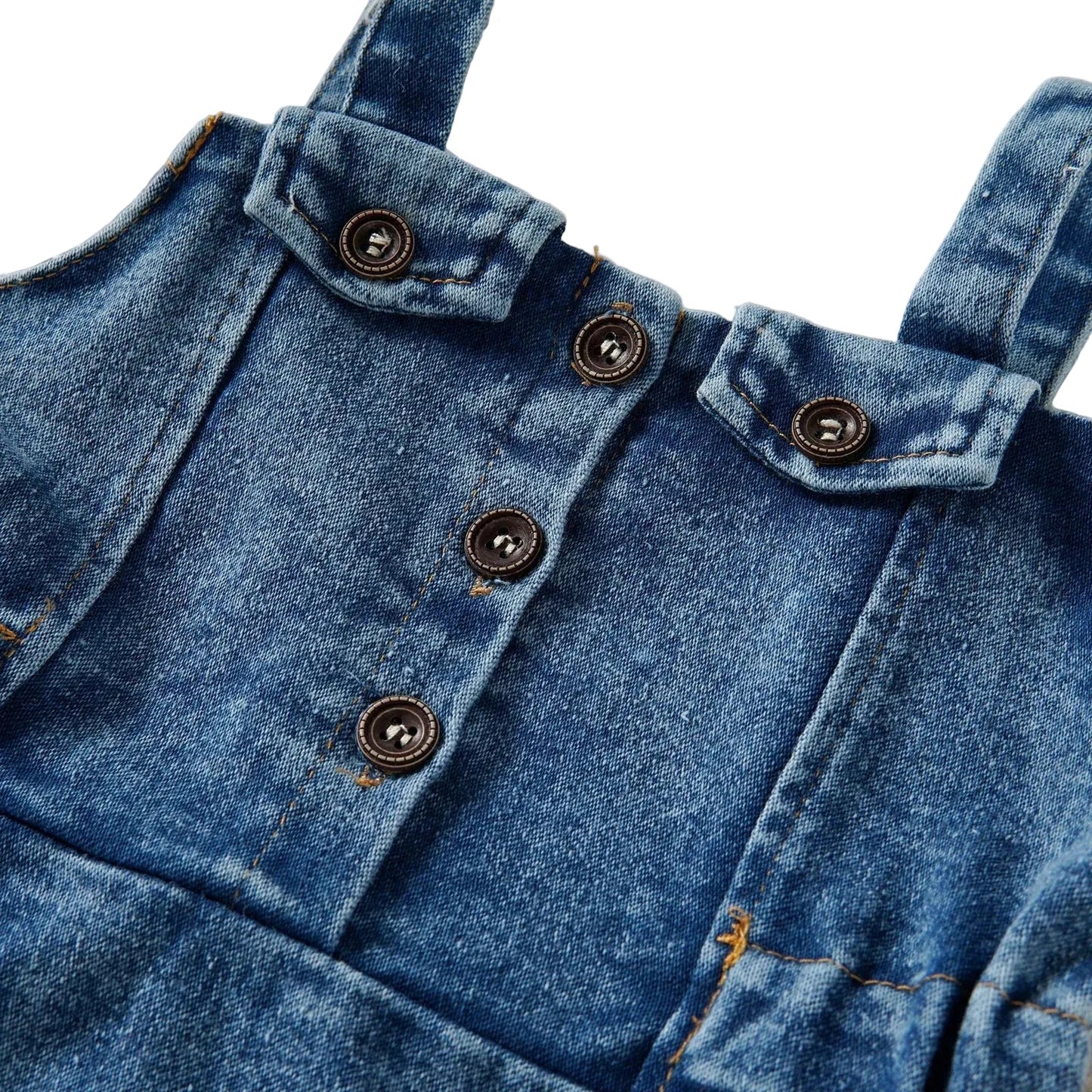 Close-up detail of the front buttons, straps, and denim fabric texture on the baby girls pinafore dress.