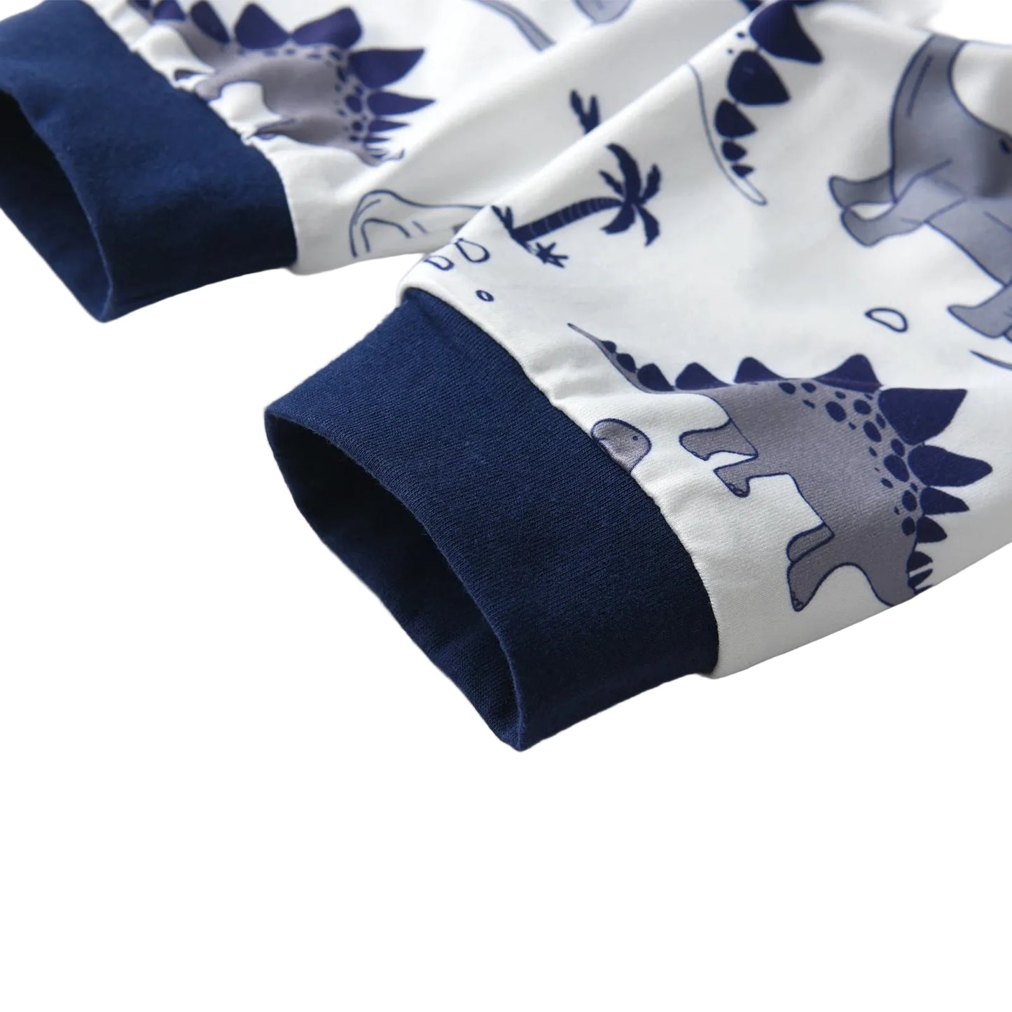 Close-up of the navy blue banded ankle cuffs on the baby boy pants, highlighting the dinosaur, cloud, and palm tree fabric pattern.