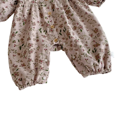Close-up of the full-length pant legs featuring gently elasticized ankle cuffs and bottom snaps on the floral baby jumpsuit.
