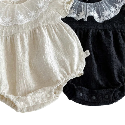 Bottom view of the Eleanor baby romper showing the convenient, high-quality inner snap closures for easy diaper changes.