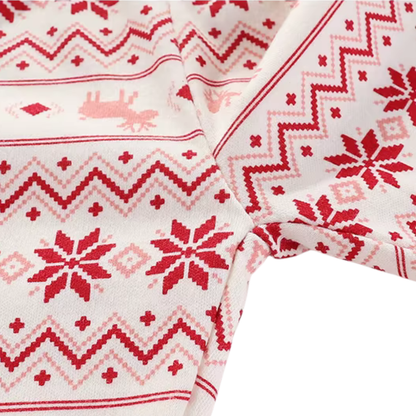 Detailed close-up of pink and red reindeer and snowflake Fair Isle print pattern