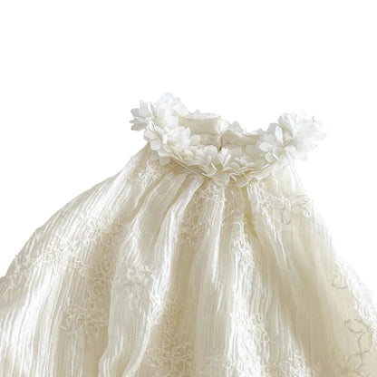 Close-up of the elegant 3D floral applique neckline on the white boho baby romper.