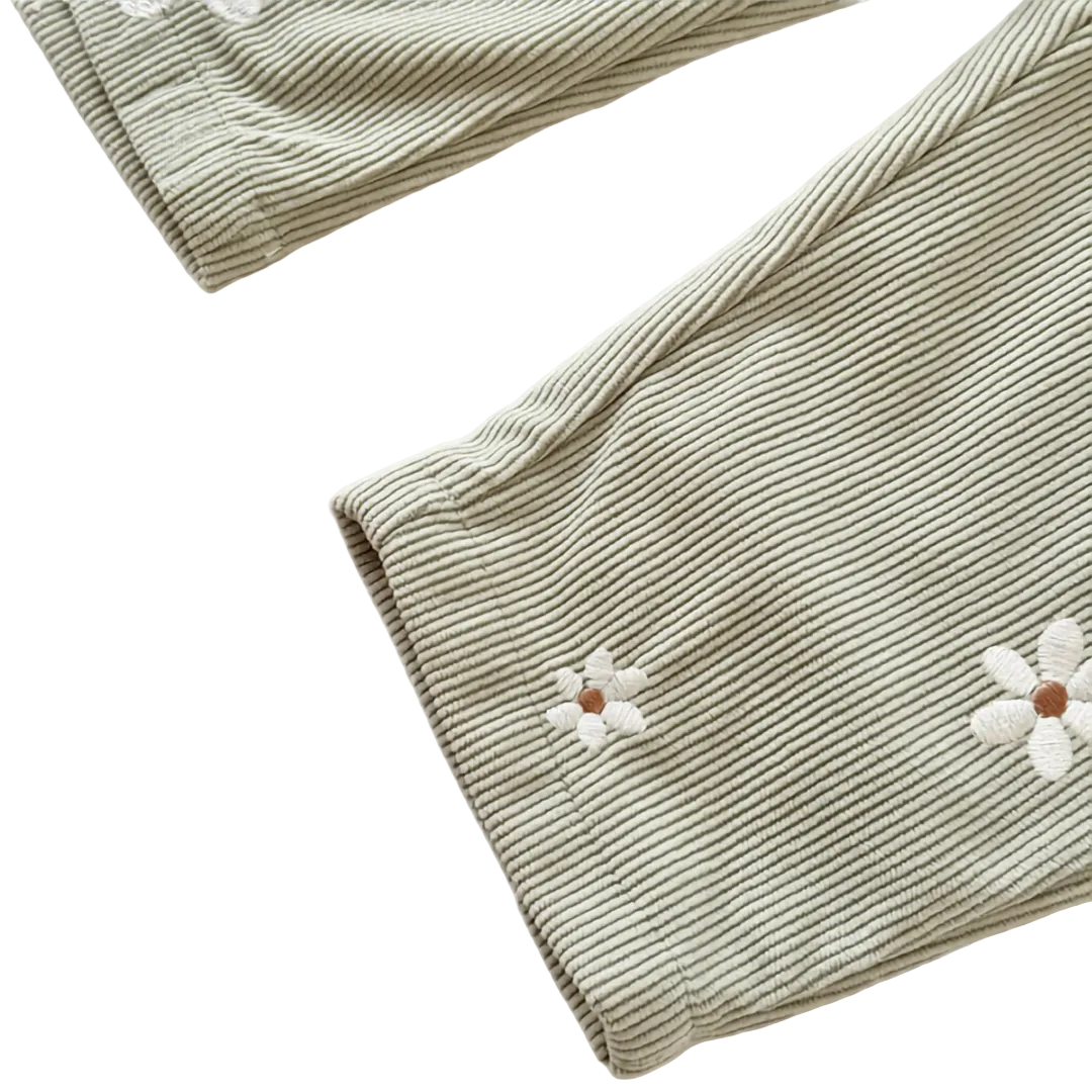 Close-up detail of the leg cuff and white daisy embroidery on the Sage Green ribbed baby overalls.