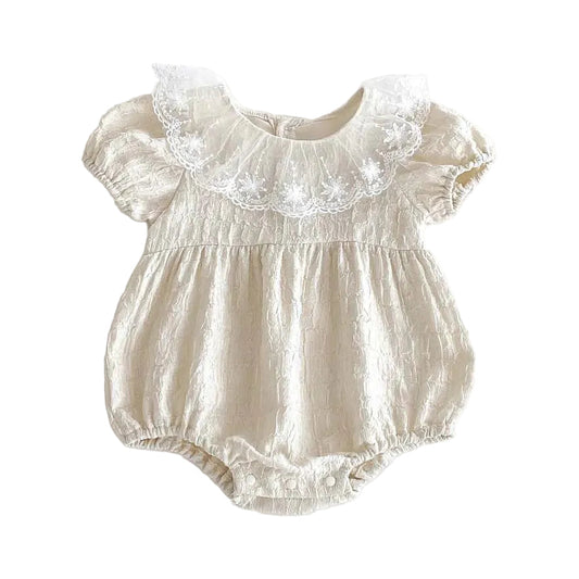 Infant girl Heritage Cream textured romper featuring an oversized floral lace Peter Pan collar for a vintage wedding aesthetic.