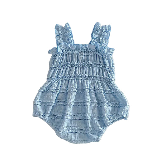 French Blue sleeveless cotton baby girl bubble romper featuring delicate smocking and ruffles, flat lay on white background.