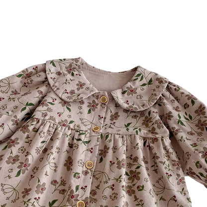 Close-up showing the gently gathered chest and earthy floral pattern on the vintage mauve baby jumpsuit.