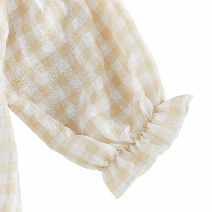 Close-up of the long sleeve featuring a gentle elastic ruffled cuff on the beige gingham baby romper.