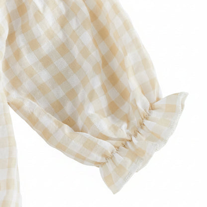 Close-up of the long sleeve featuring a gentle elastic ruffled cuff on the beige gingham baby romper.
