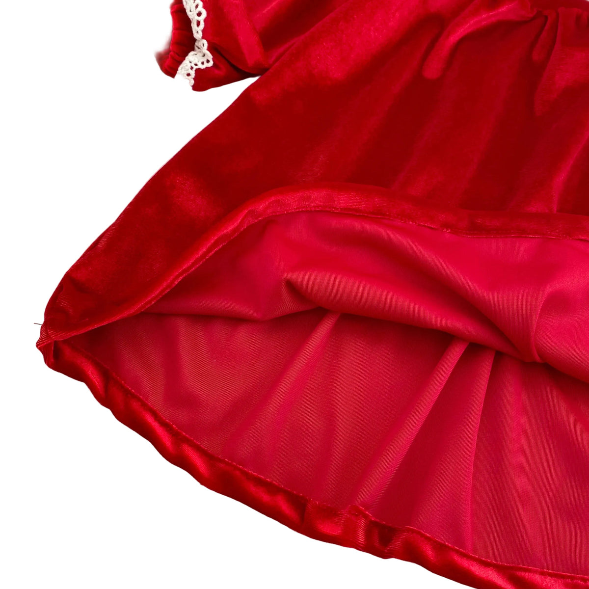 Close up of hemline and comfortable inner lining on girls cherry red velvet holiday dress