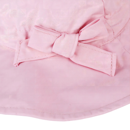 Close-up macro view of the high-quality stitching and decorative fabric bow detail on the side of the pink cotton sun hat.