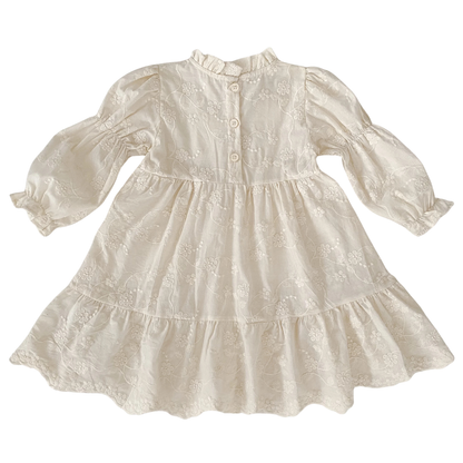 Back view of girls ivory floral embroidered cottagecore dress showing back button closures and high collar.