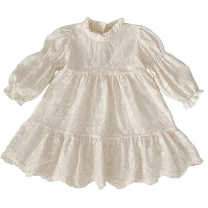 Front view of girls ivory floral embroidered cottagecore dress with long bishop sleeves and tiered A-line skirt.