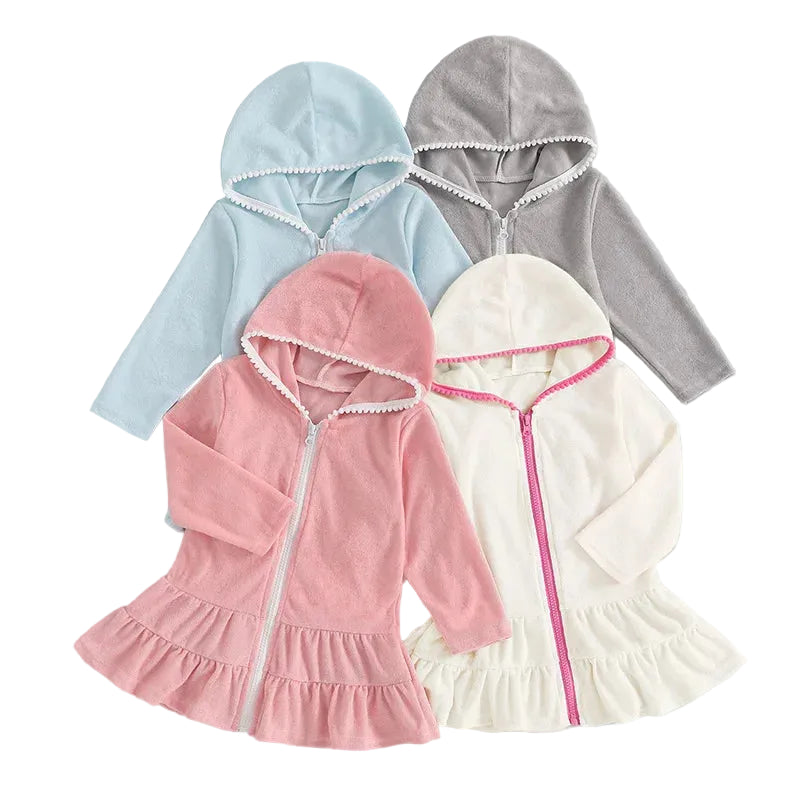 Group shot of long sleeve girls' hooded zip-up swim coverups in pink, light blue, white, and grey colors with pom-pom trim.