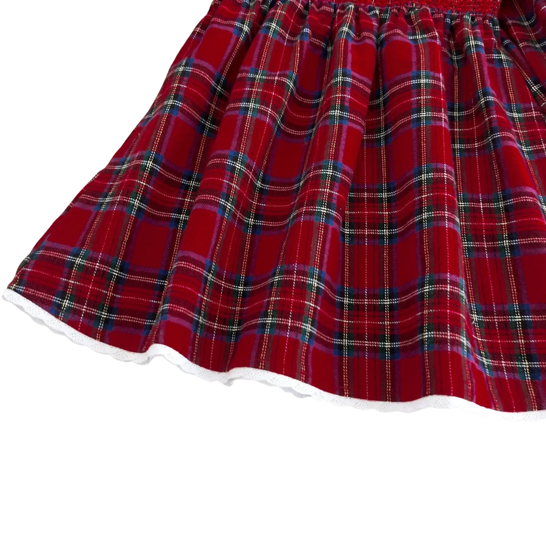 Hemline detail of girls long sleeve red plaid smocked holiday dress